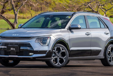Foto exibindo o Kia Niro SX Prestige 2024 estacionado, exibindo a frente e as portas do lado do motorista.