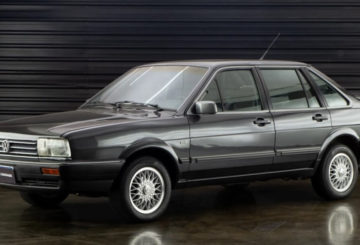 Foto mostrando a lateral esquerda de um Volkswagen Santana G1 cinza estacionado.